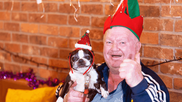Jim and his dog Minnie in Christmas hats