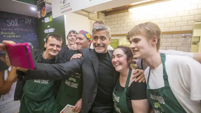George Clooney takes a selfie with four staff at Social Bite