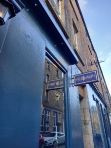 Exterior of a restaurant, blue walls and a sign that reads 'Bon Vivant'